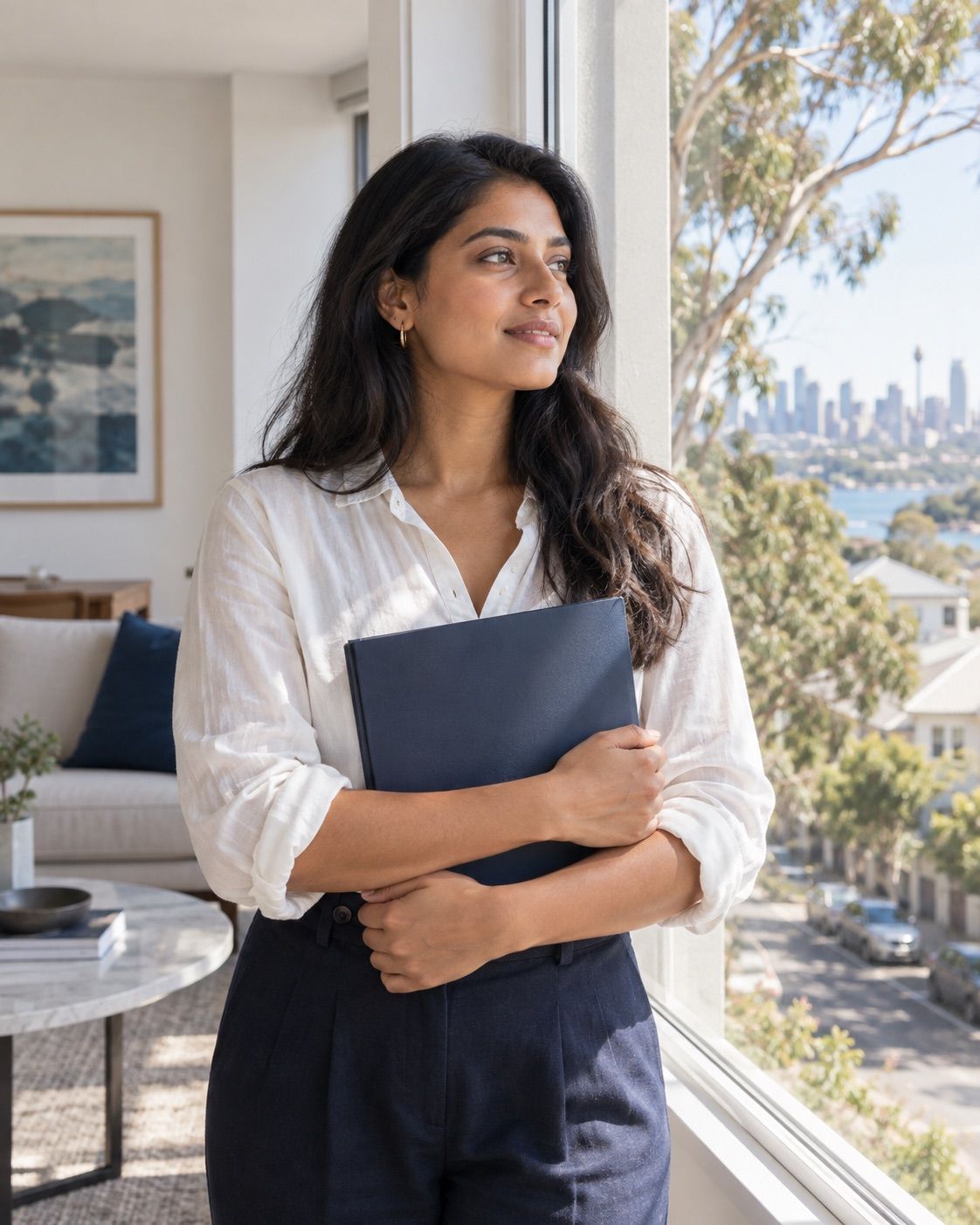 Woman holding a folder beside an apartment window